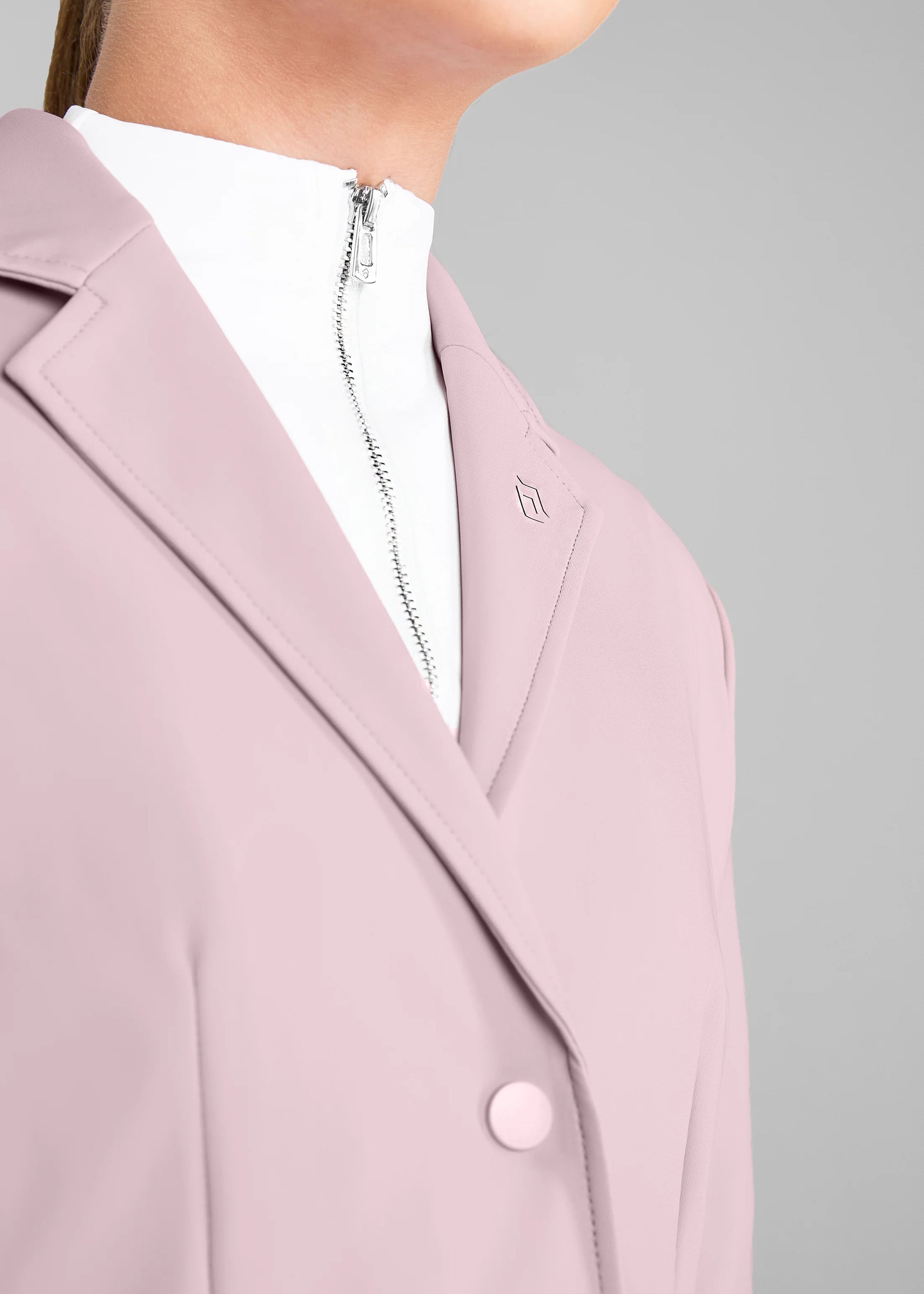 Pink coat with a brand logo on a gray background