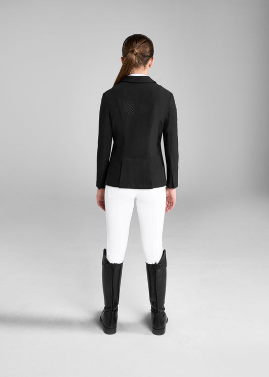 Person wearing a black equestrian jacket, white pants, and black boots on a gray background